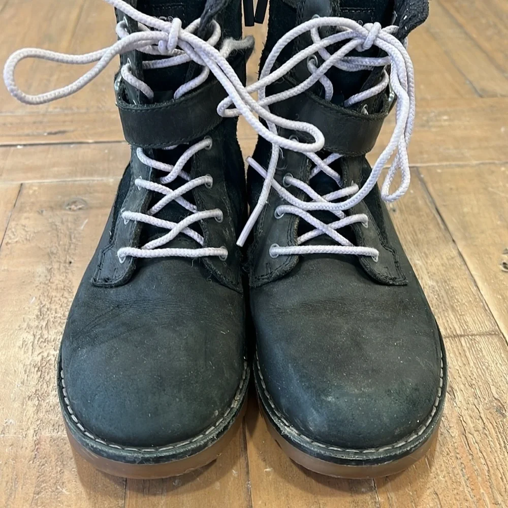 Ugg Koren black leather buckle strap lug sole boots